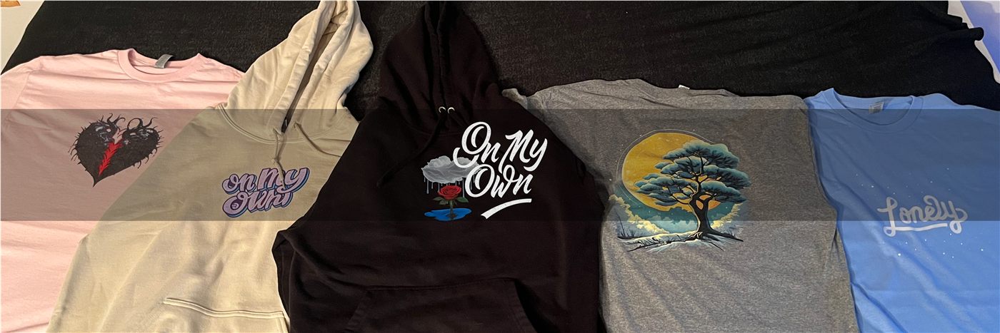 Five On My Own garments laid out together: hoodies and t-shirts in pink, sand, black, grey and blue